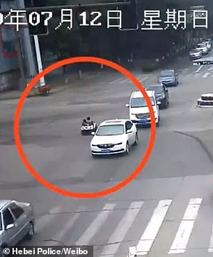 CCTV footage shows the pair sitting in a fake SUV model on the crossroad